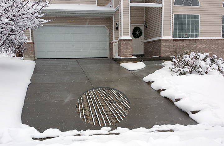 Electric heated driveway — concrete cutaway showing embedded heating cables